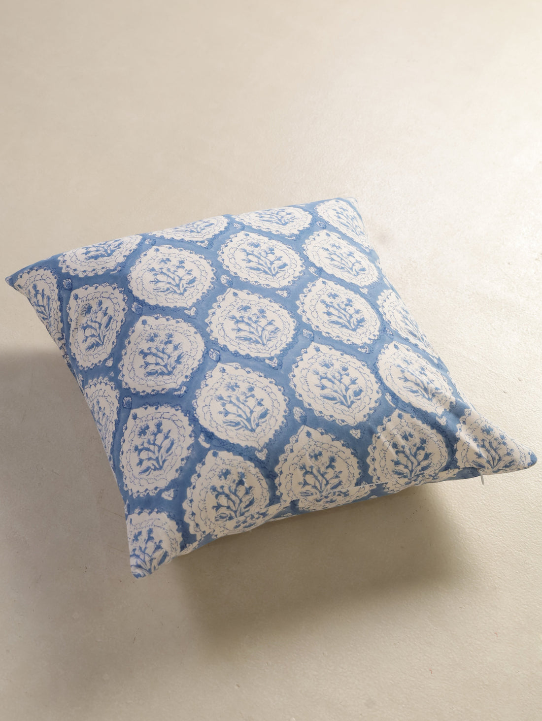 The Block & Bloom dusty blue cotton cushion cover featuring a hand block printed floral buta motif in scalloped frames.
