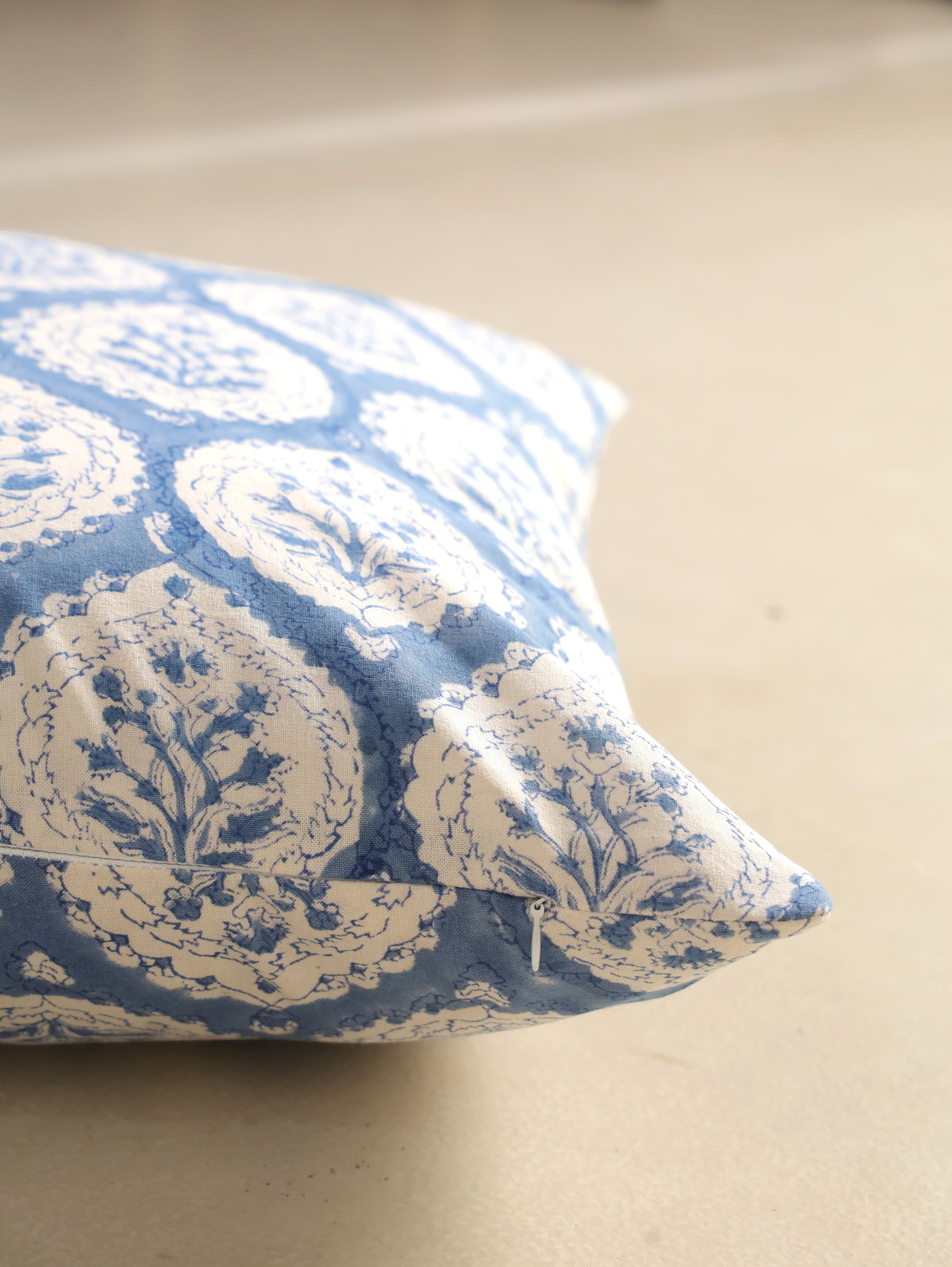 The Block & Bloom dusty blue cotton cushion cover with hand block printed floral buta motifs and scalloped frames.