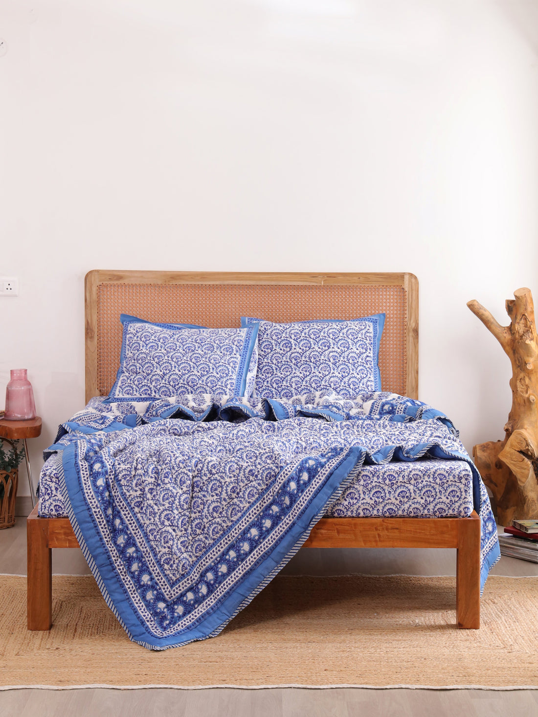 The Block & Bloom Blue Vine Bloom 4pc cotton bedding set with blue and white floral vine print on a wooden bed frame.