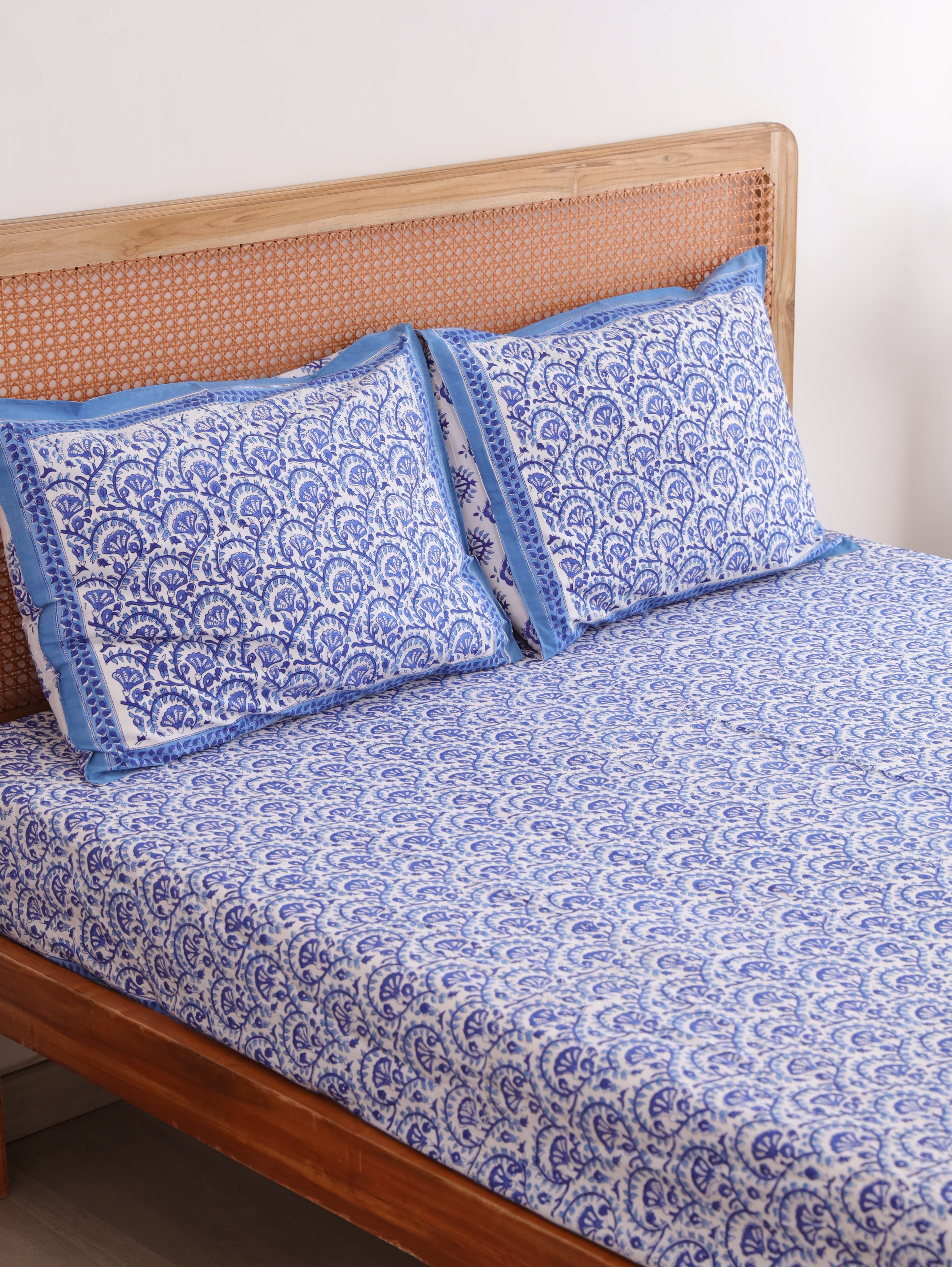 The Block & Bloom blue and white cotton percale fitted sheet and matching pillowcases with traditional vine block print.