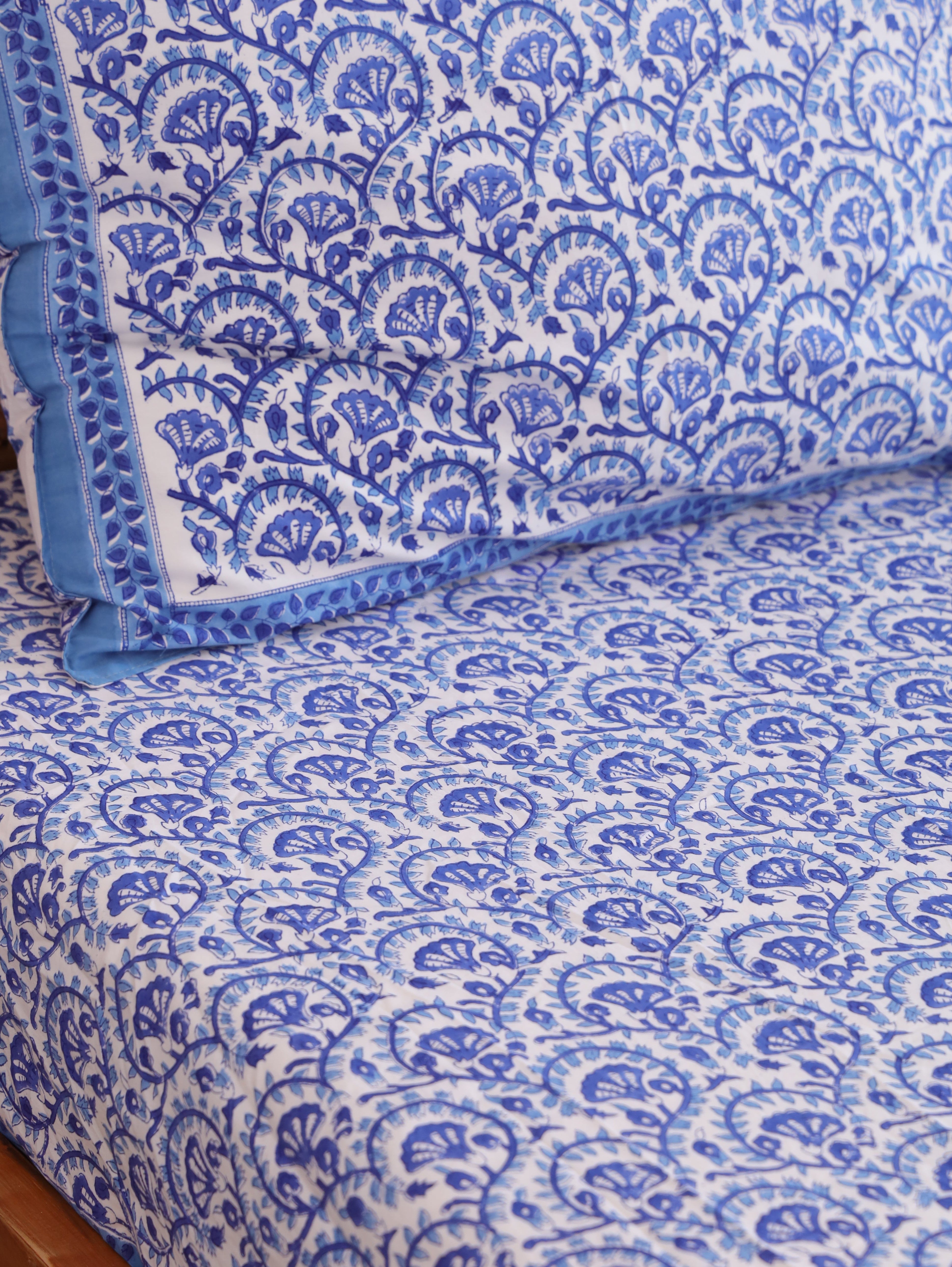 The Block & Bloom blue and white hand block printed cotton percale fitted sheet and matching pillowcase set.