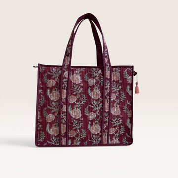 The Block & Bloom burgundy quilted tote bag with pink rose floral print and green foliage, featuring a structured base.