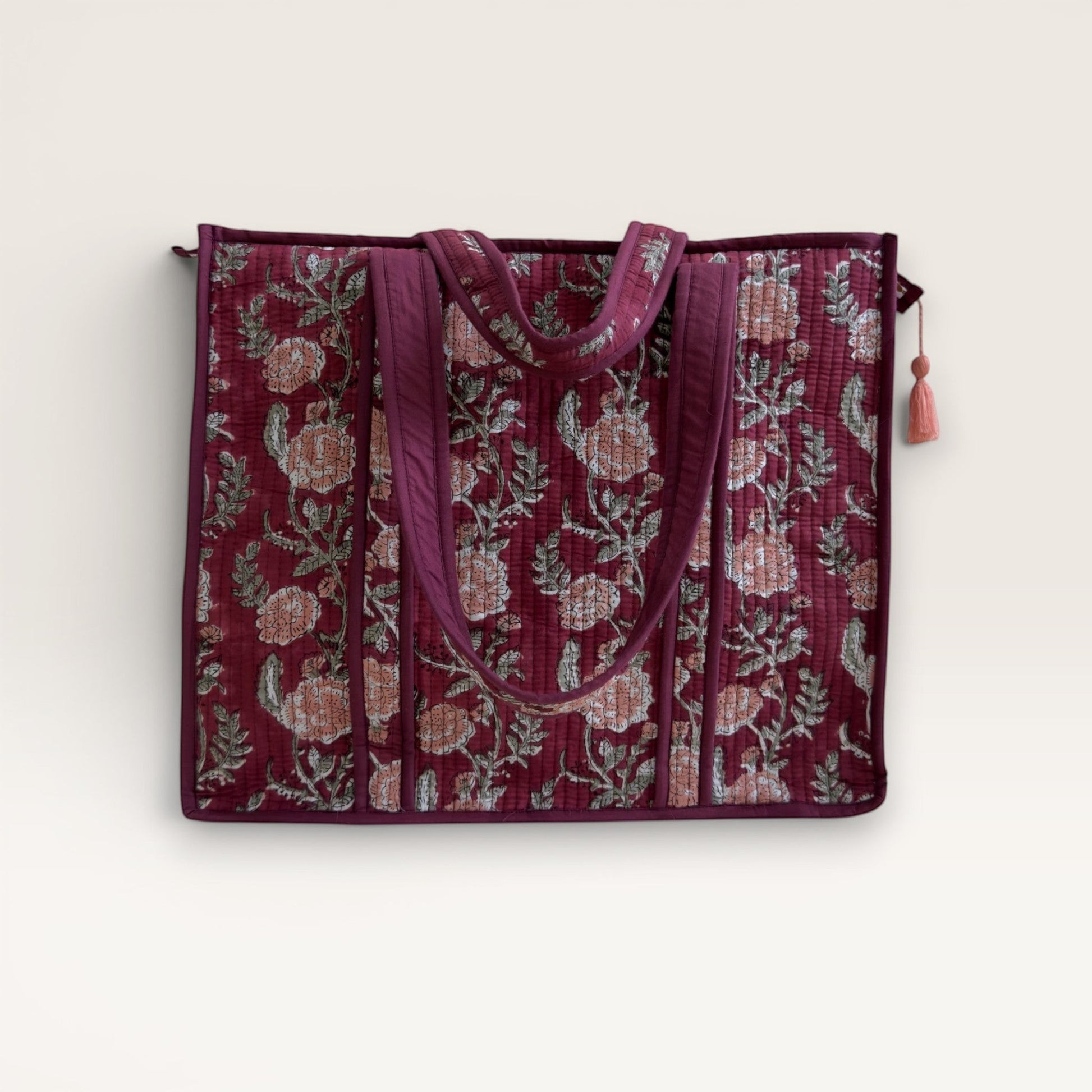 The Block & Bloom burgundy quilted tote bag with pink rose floral block print and sturdy shoulder straps.