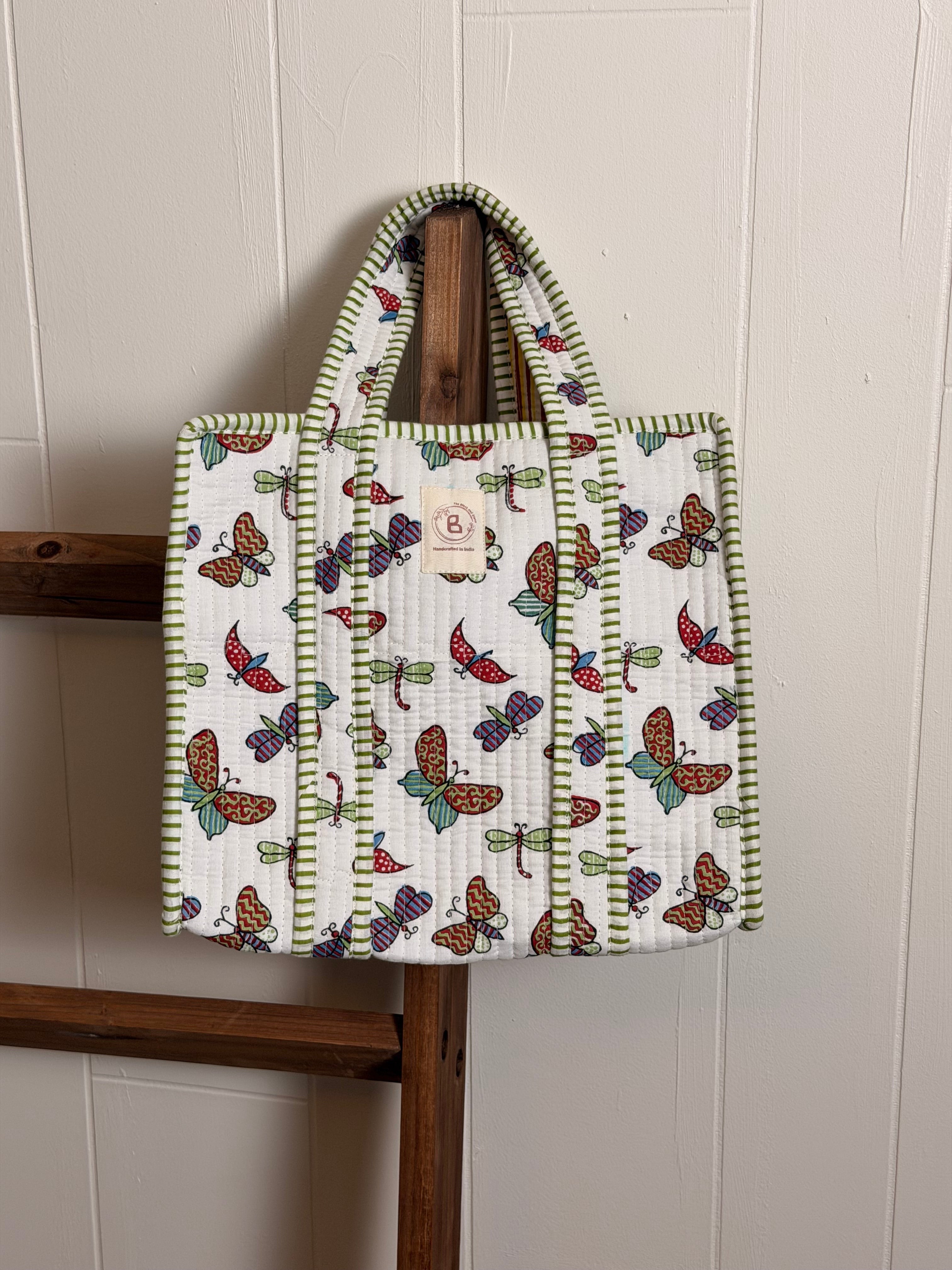 The Block & Bloom quilted mini tote featuring a white fabric with hand block-printed colorful butterflies and dragonflies.