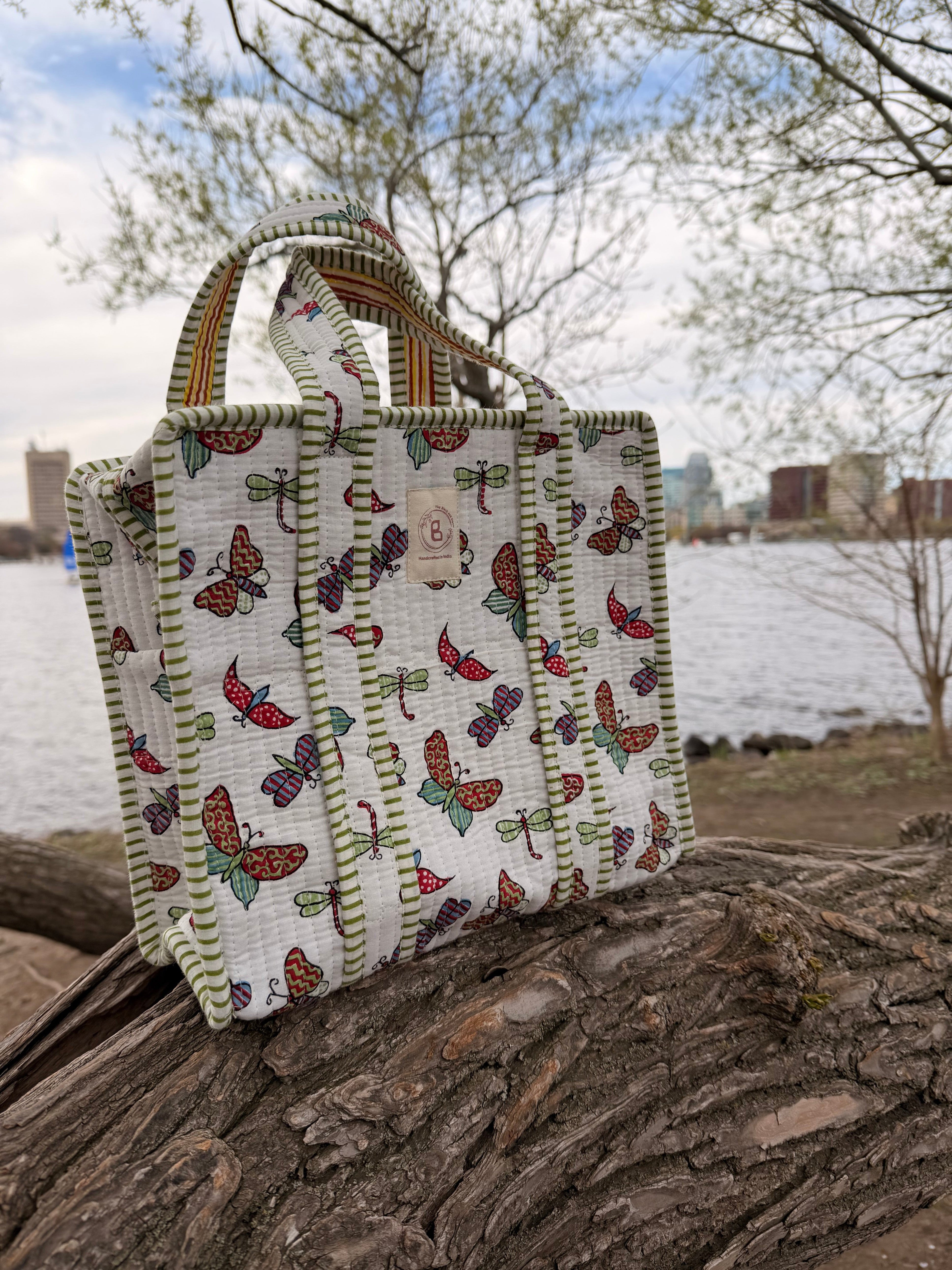 The Block & Bloom quilted mini tote featuring a colorful butterfly and dragonfly print with green striped trim.