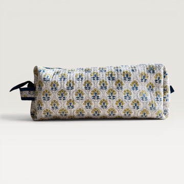 The Block & Bloom Cosmos Tile quilted hair tool organizer bag with blue and yellow floral motifs on white fabric.