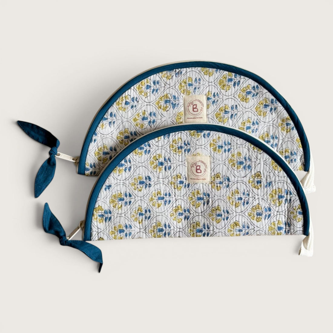 The Block & Bloom Cosmos Tile quilted cotton makeup brush pouch with blue and yellow floral lattice print.