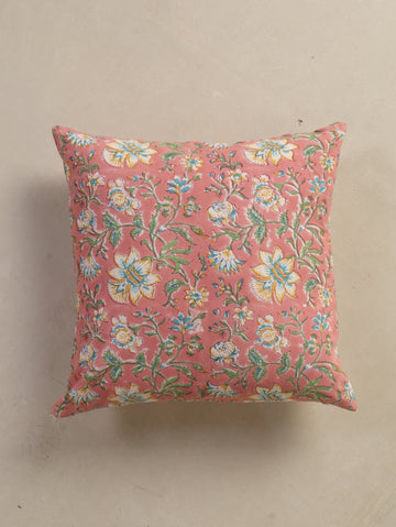 The Block & Bloom hand block printed cotton cushion cover in dusty rose with white, yellow, and teal floral patterns.
