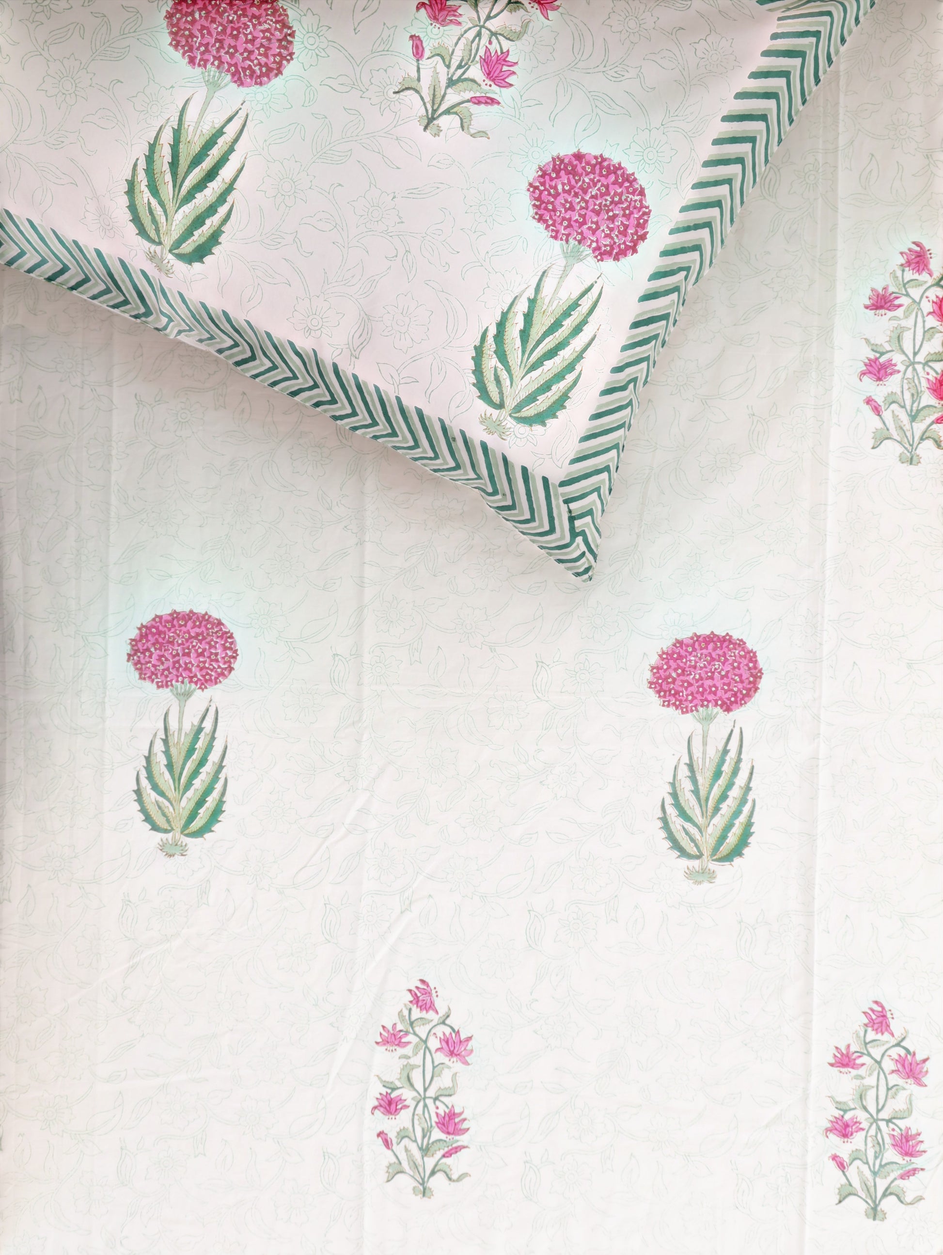 The Block & Bloom hand block printed cotton percale bedsheet with pink floral motifs and green striped border pillowcase