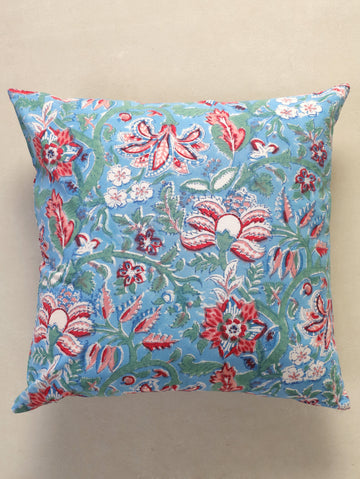 The Block & Bloom hand block printed cotton cushion cover featuring red, rose, and white floral patterns on blue.