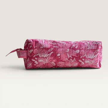 The Block & Bloom quilted hair tool organizer bag in pink and white floral lily print with a secure zipper closure.