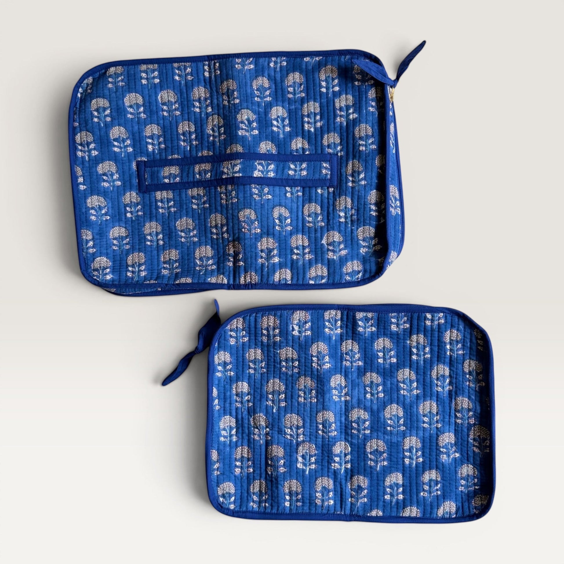 The Block & Bloom indigo blue quilted cotton laptop sleeve with hand block-printed marigold floral patterns.