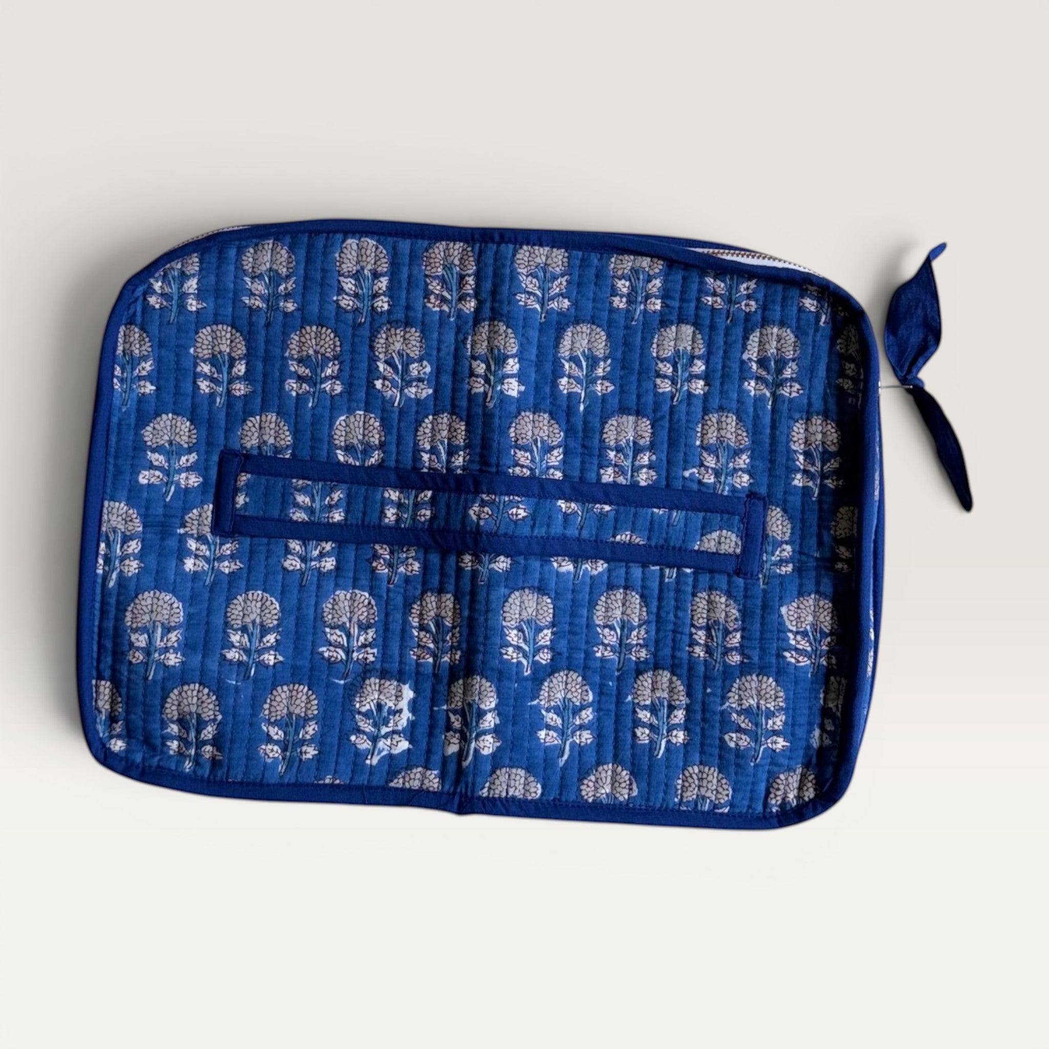 The Block & Bloom indigo blue quilted cotton laptop sleeve with hand block-printed marigold floral patterns.