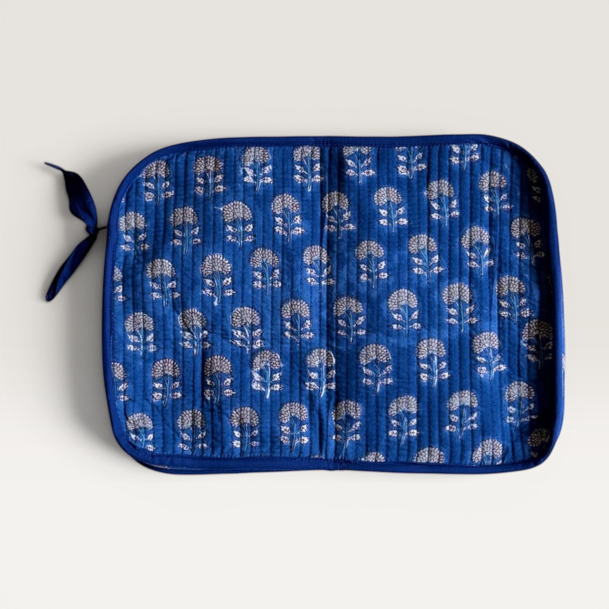 The Block & Bloom indigo blue quilted cotton laptop sleeve with hand block-printed marigold floral motifs and YKK zipper