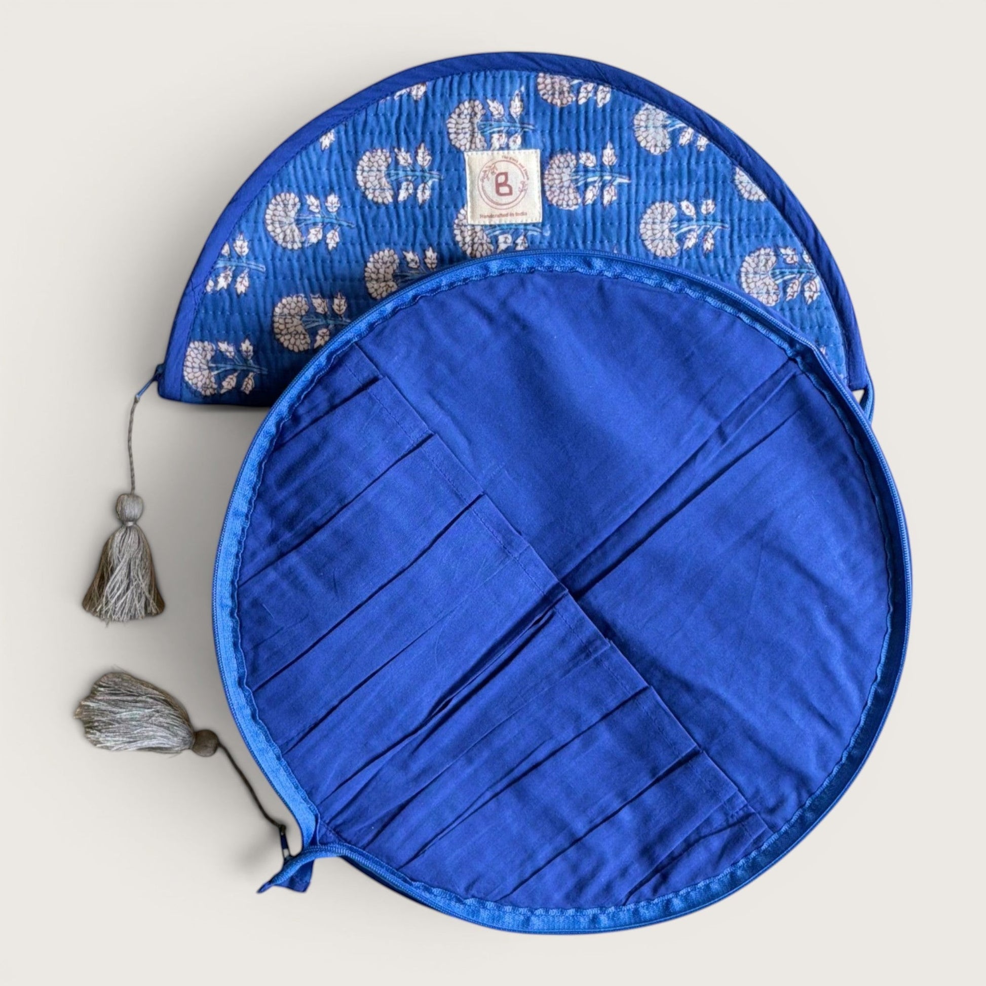 The Block & Bloom indigo blue quilted makeup brush pouch with marigold floral print and internal brush storage slots.