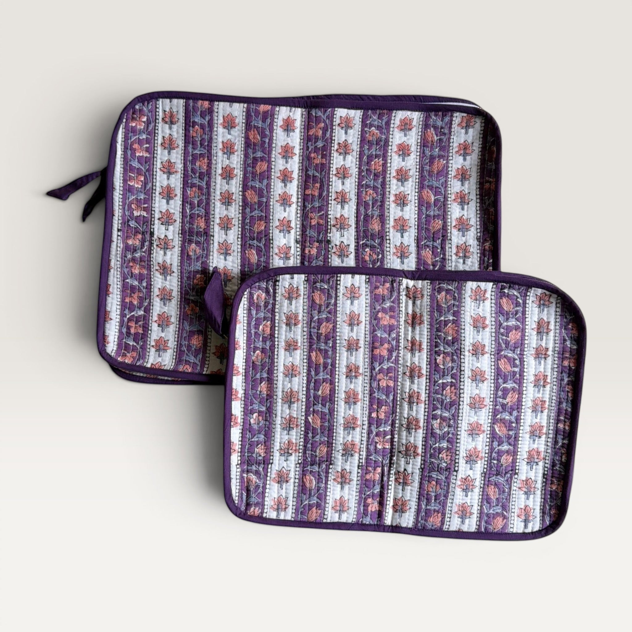 The Block & Bloom quilted laptop sleeve with lavender and ivory floral vine stripes and a hand-stitched fabric bow.