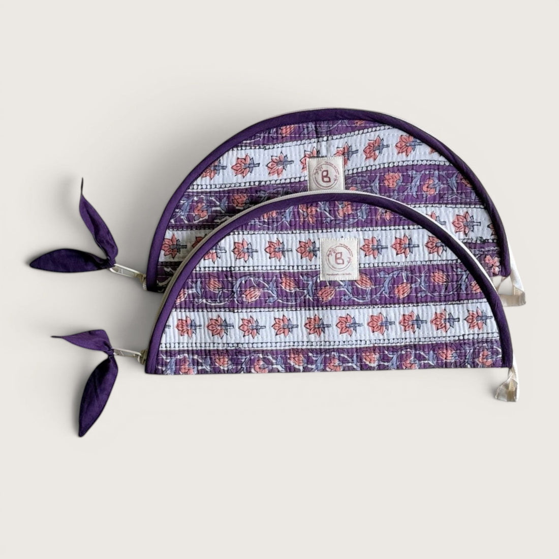 The Block & Bloom lavender quilted cotton makeup brush pouches with floral vine print and purple zipper pulls.