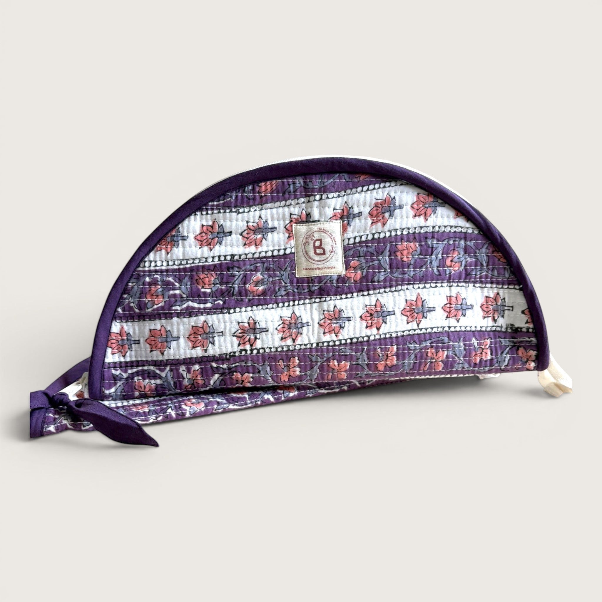 The Block & Bloom quilted makeup brush pouch in lavender with white floral vine pattern and tie closure.