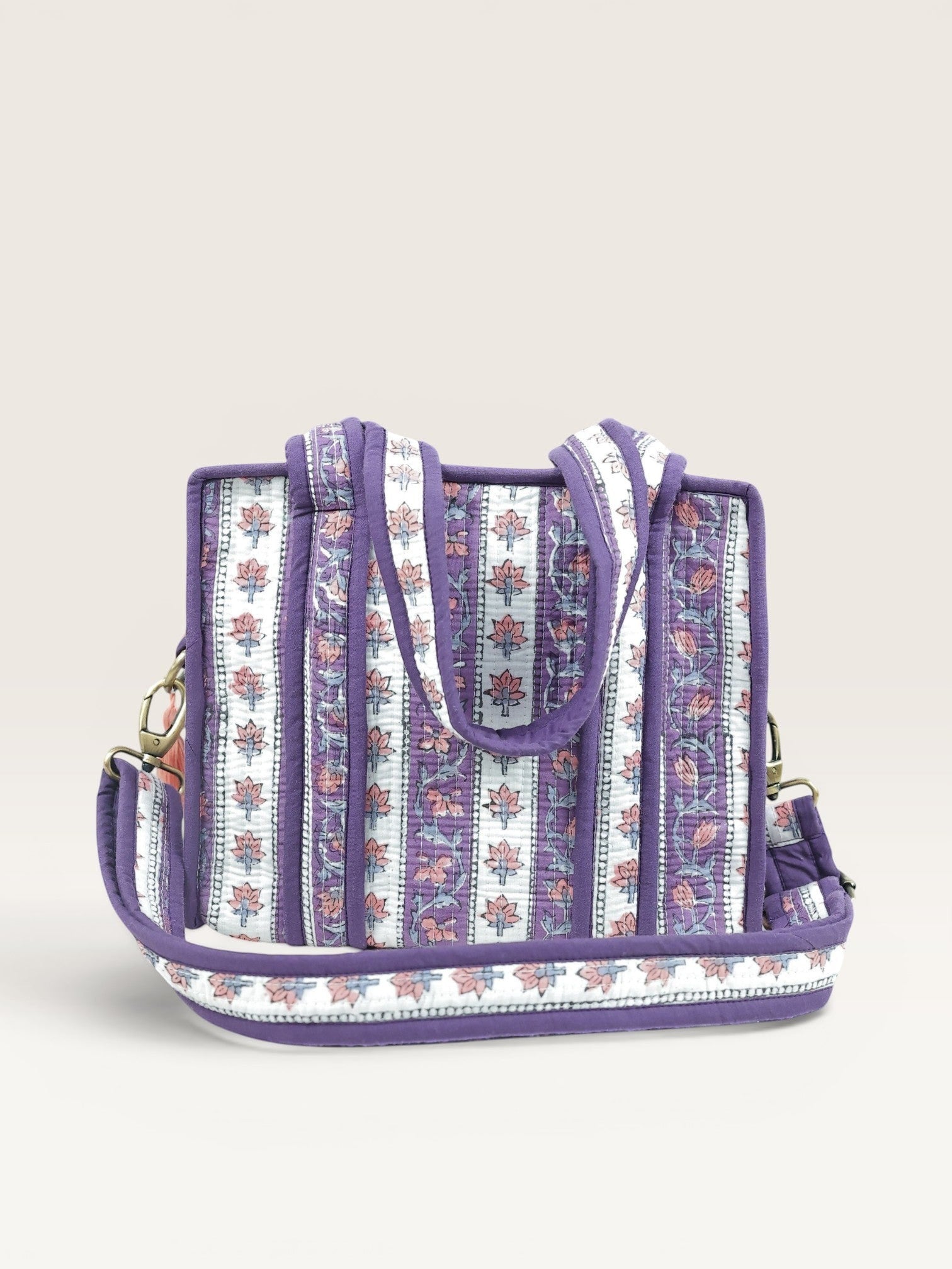 The Block & Bloom lavender quilted mini tote bag with floral block print stripes, padded handles, and brass hardware.