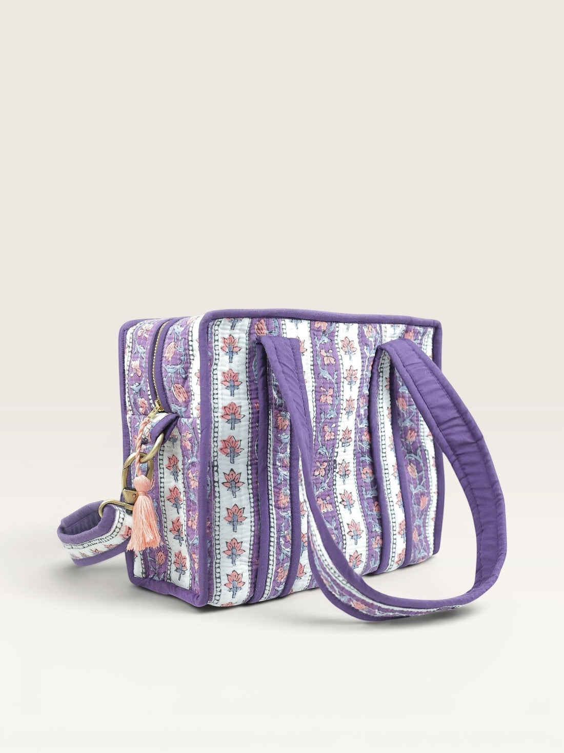 The Block & Bloom lavender quilted mini tote bag with floral block print stripes, padded handles, and brass hardware.