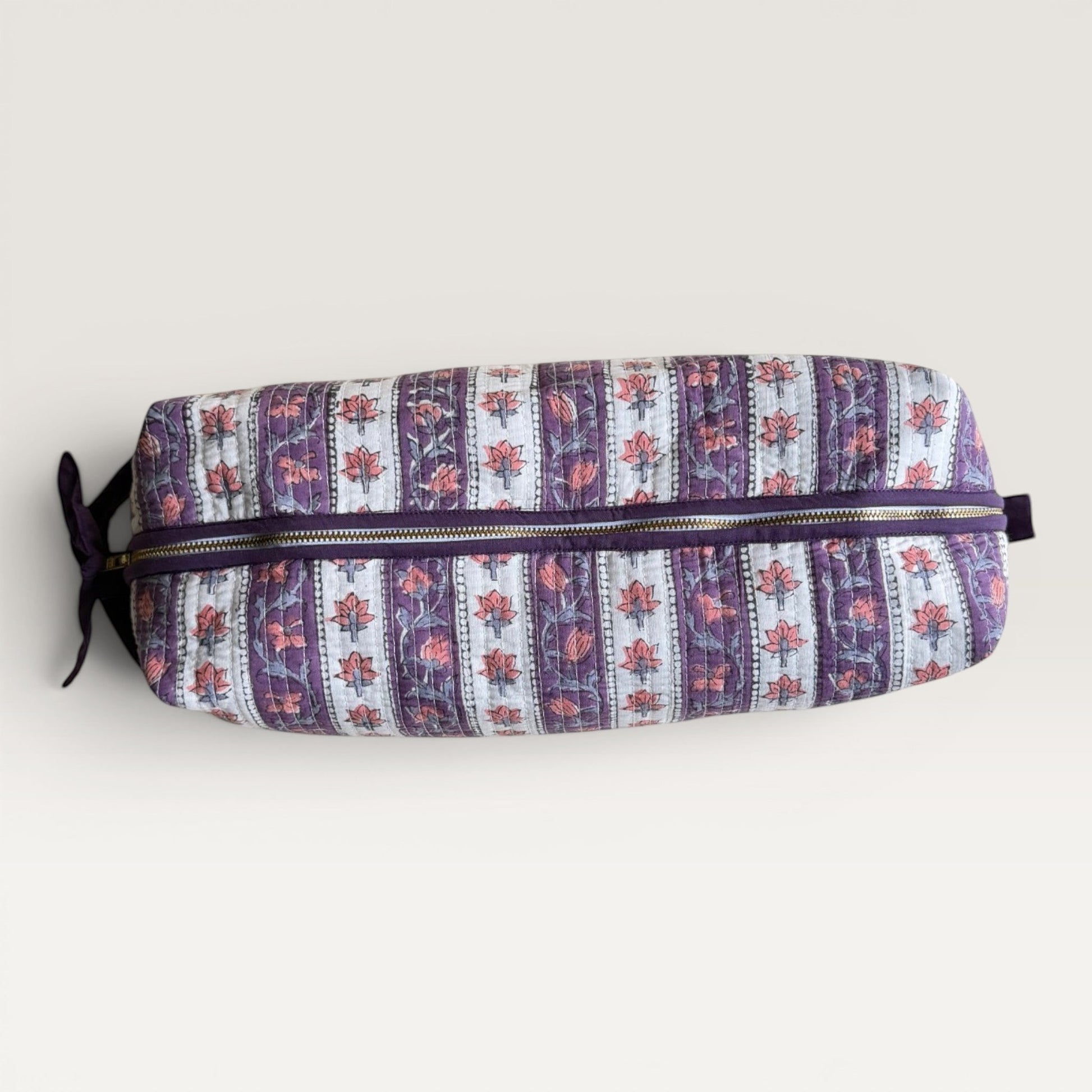 The Block & Bloom Lavender Vine quilted hair tool organizer bag with hand block-printed floral stripes and YKK zipper.