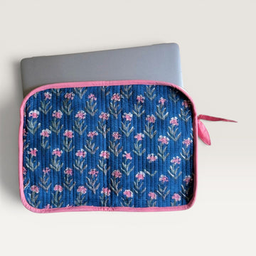 The Block & Bloom navy blue quilted laptop sleeve with pink carnation floral print and a pink fabric bow zipper pull.