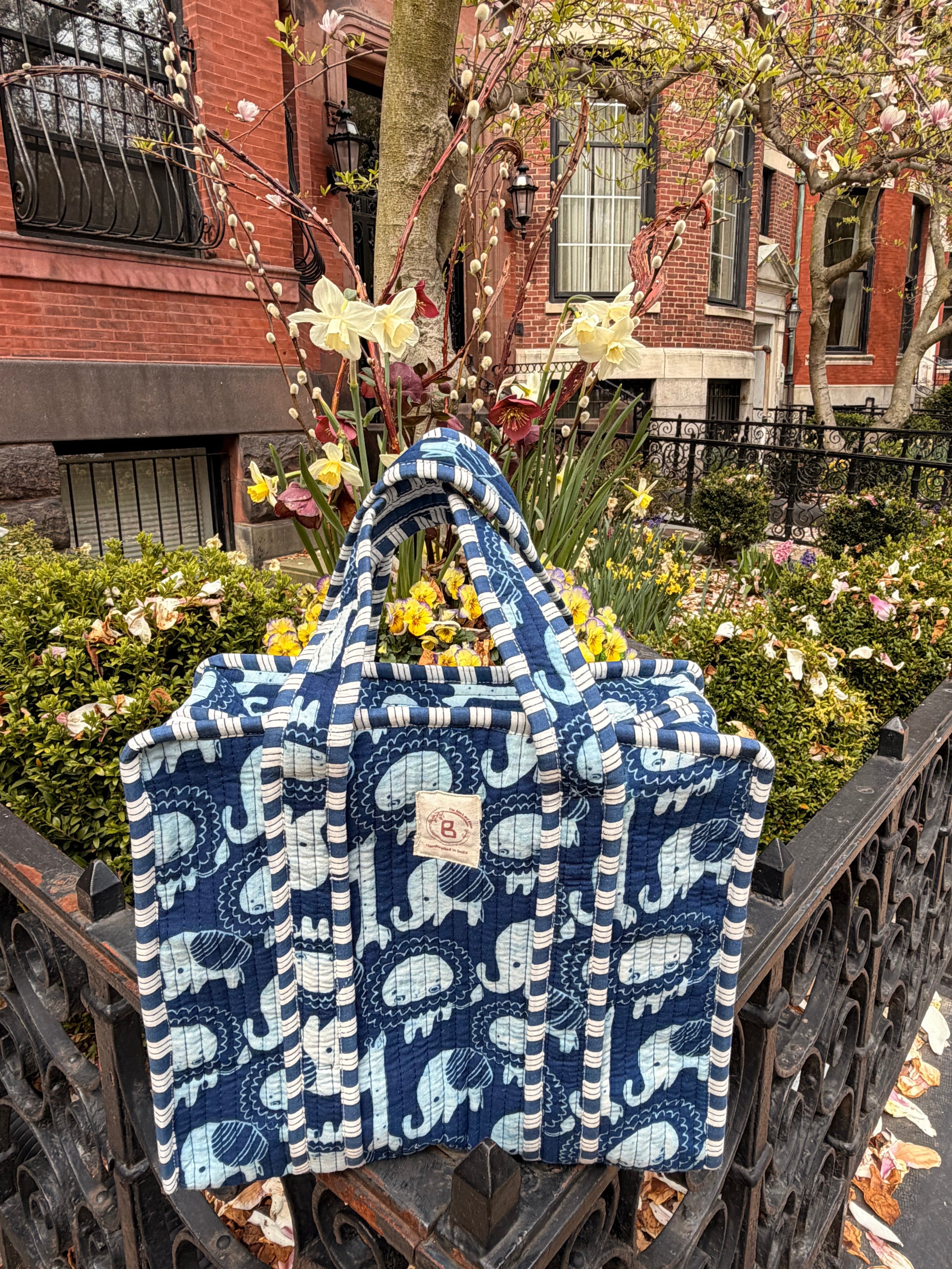 The Block & Bloom navy quilted mini tote with hand block-printed elephant motifs, featuring striped handles.
