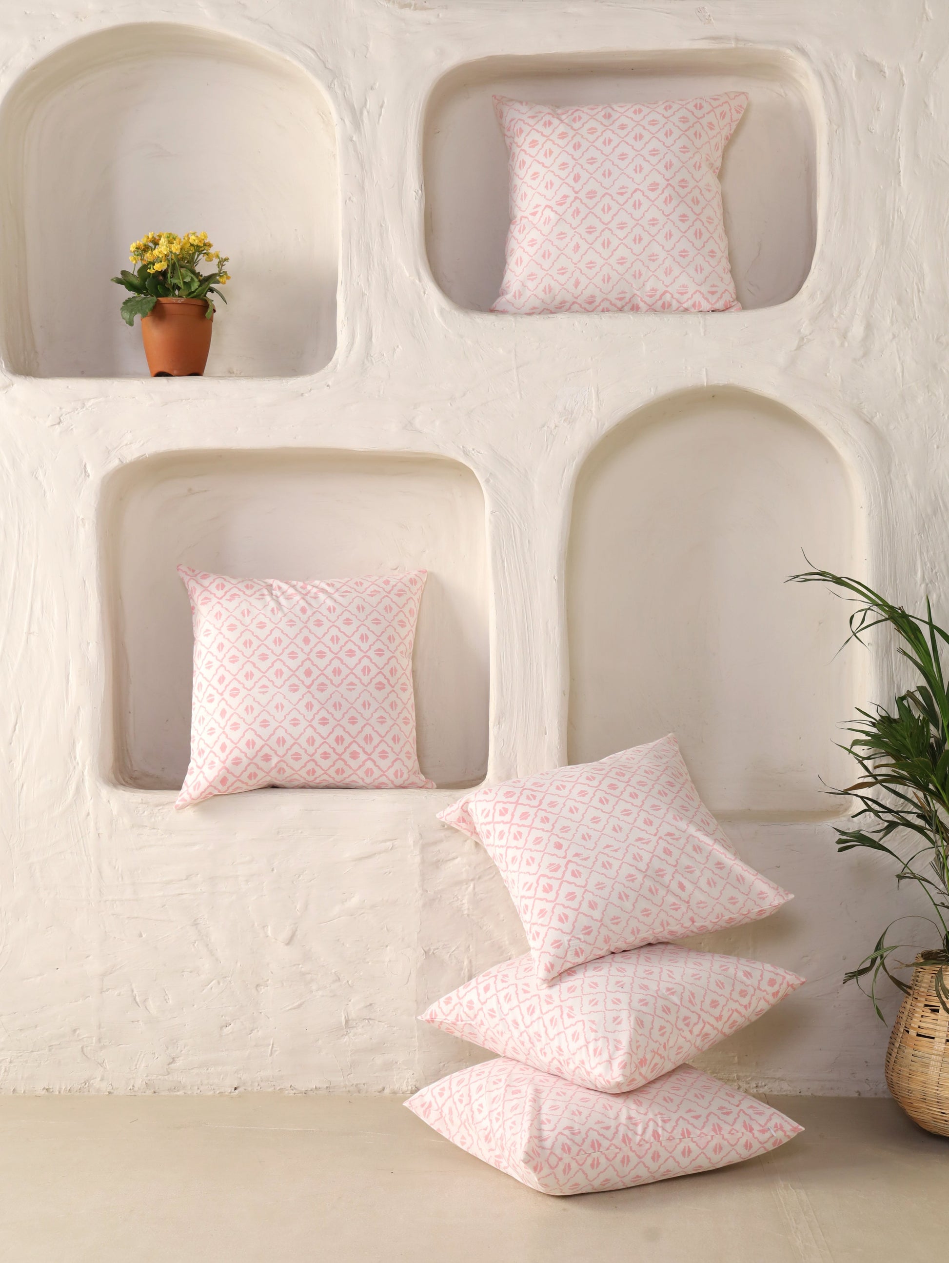 The Block & Bloom pink geometric cotton cushion covers with hand-block printed diamond lattice pattern on ivory white.