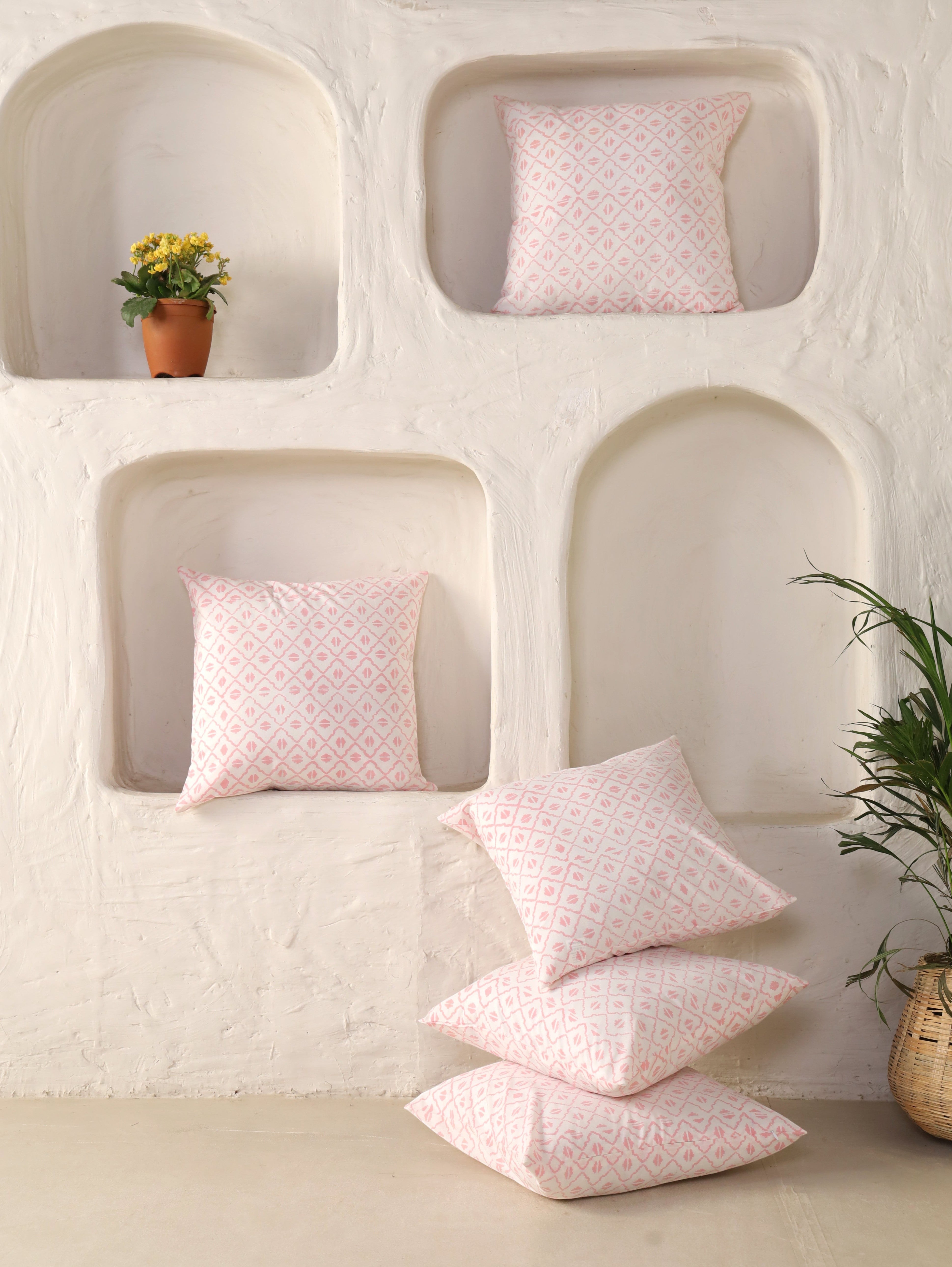 The Block & Bloom pink geometric cotton cushion covers with hand-block printed diamond lattice pattern on ivory white.