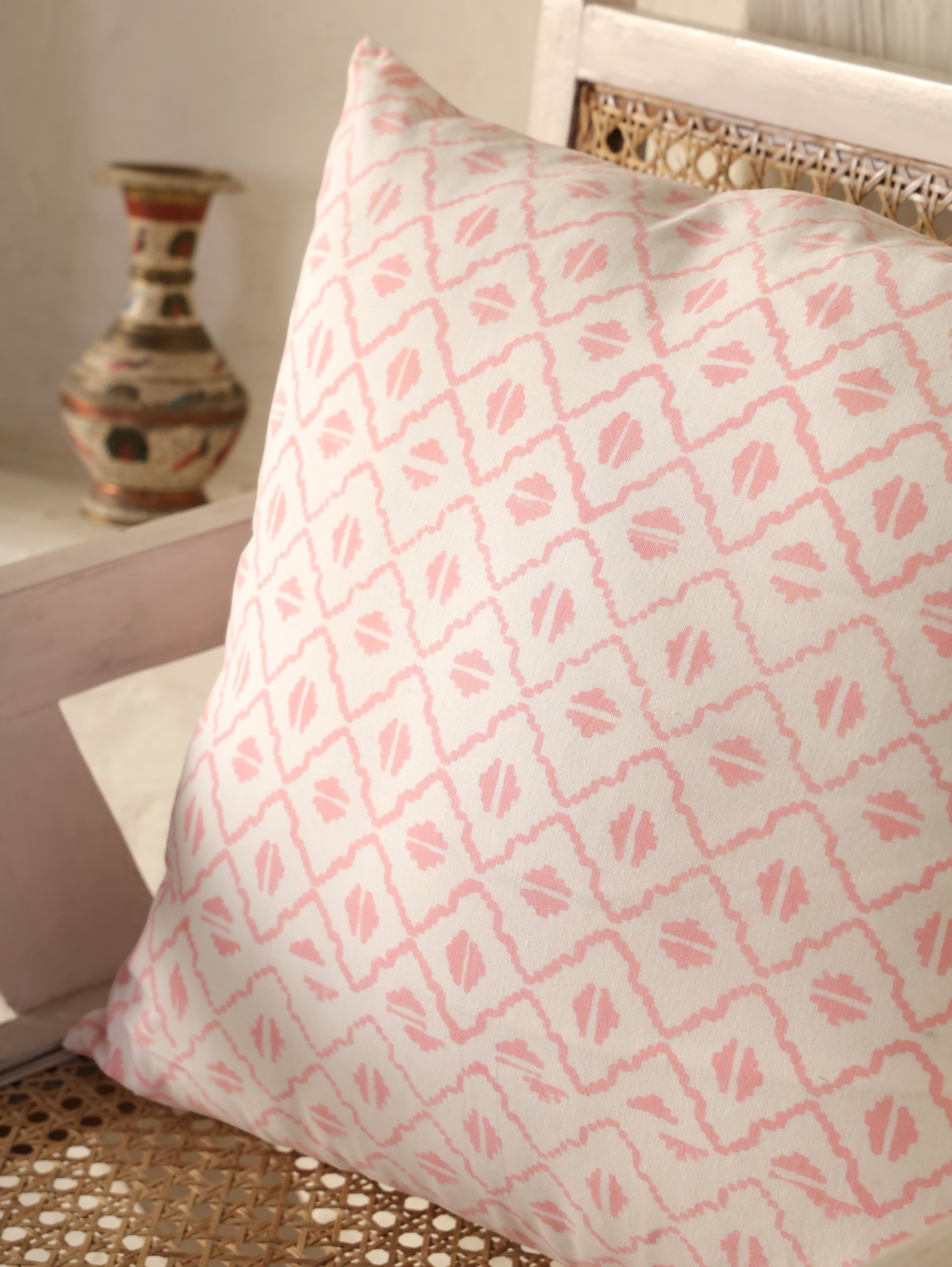 The Block & Bloom pink and ivory cotton cushion cover featuring a hand-block printed geometric diamond lattice pattern.