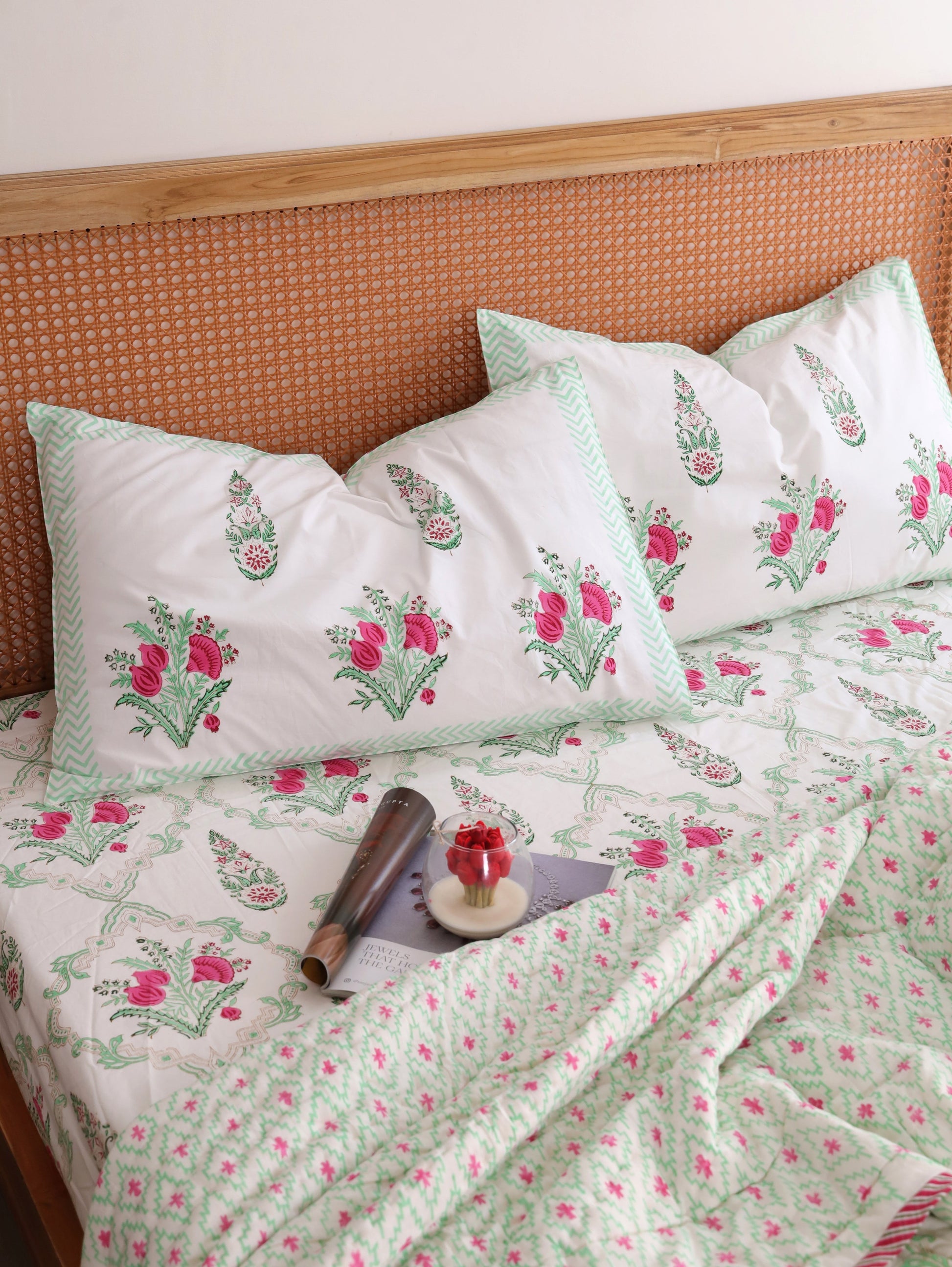 The Block & Bloom Pomegranate Meadow bedding set with pink floral block print and pistachio green chevron borders.