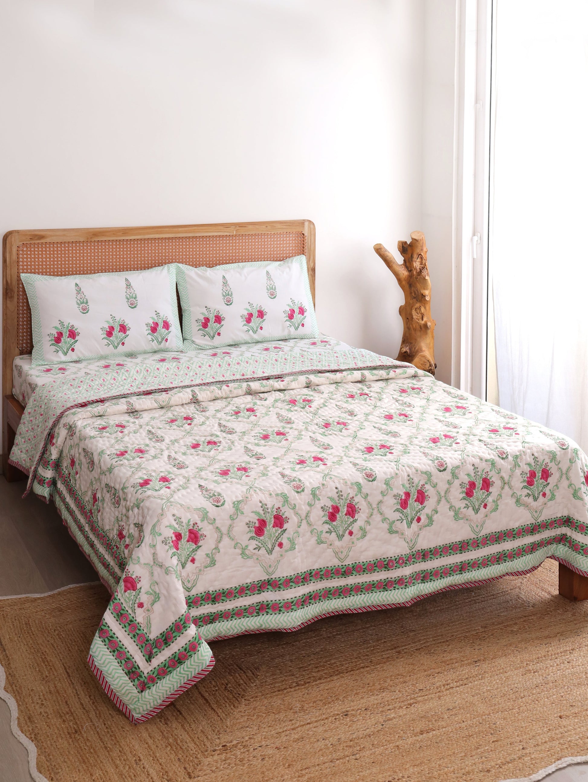 The Block & Bloom Pomegranate Meadow 4pc cotton bedding set with pink floral block prints and pistachio green borders.