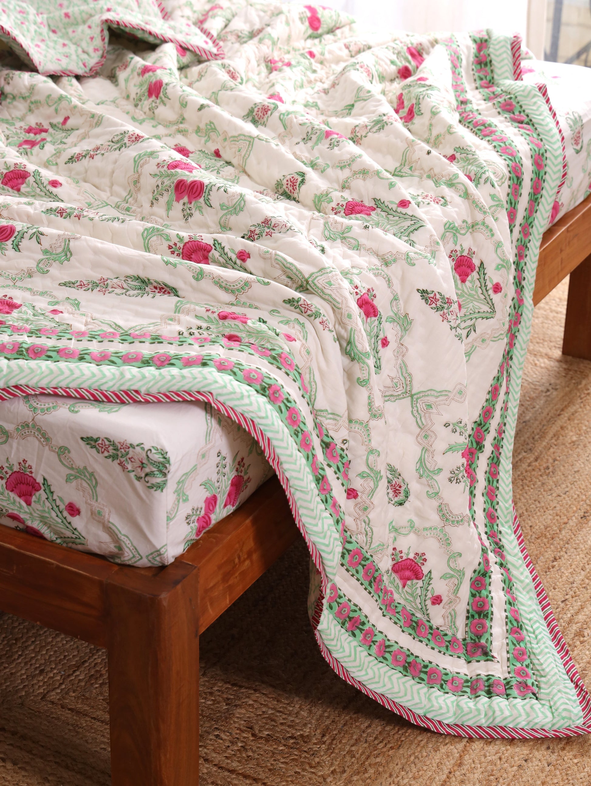The Block & Bloom Pomegranate Meadow 4pc cotton bedding set with pink floral block prints and pistachio green borders.