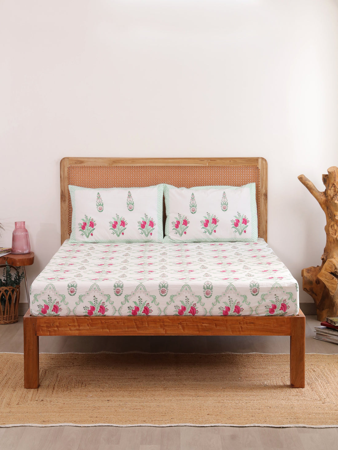 The Block & Bloom Pomegranate Meadow cotton fitted sheet and pillowcases with pink floral print on a white background.