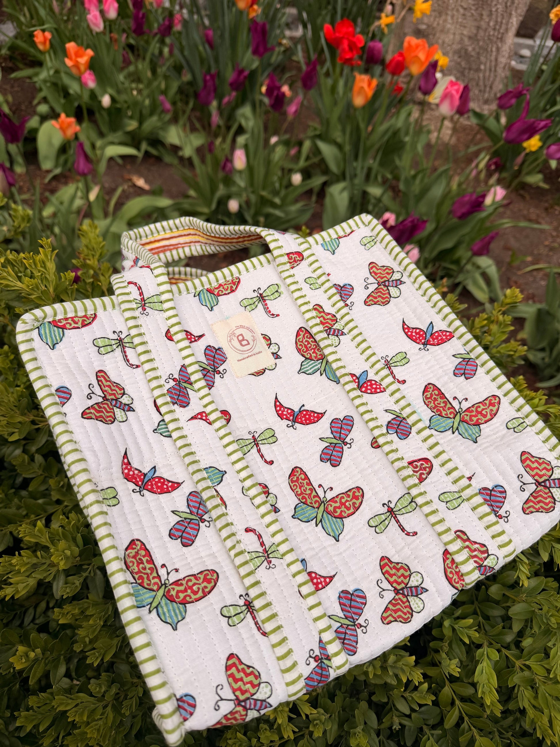 The Block & Bloom quilted mini tote featuring a colorful butterfly and dragonfly print with green striped trim.