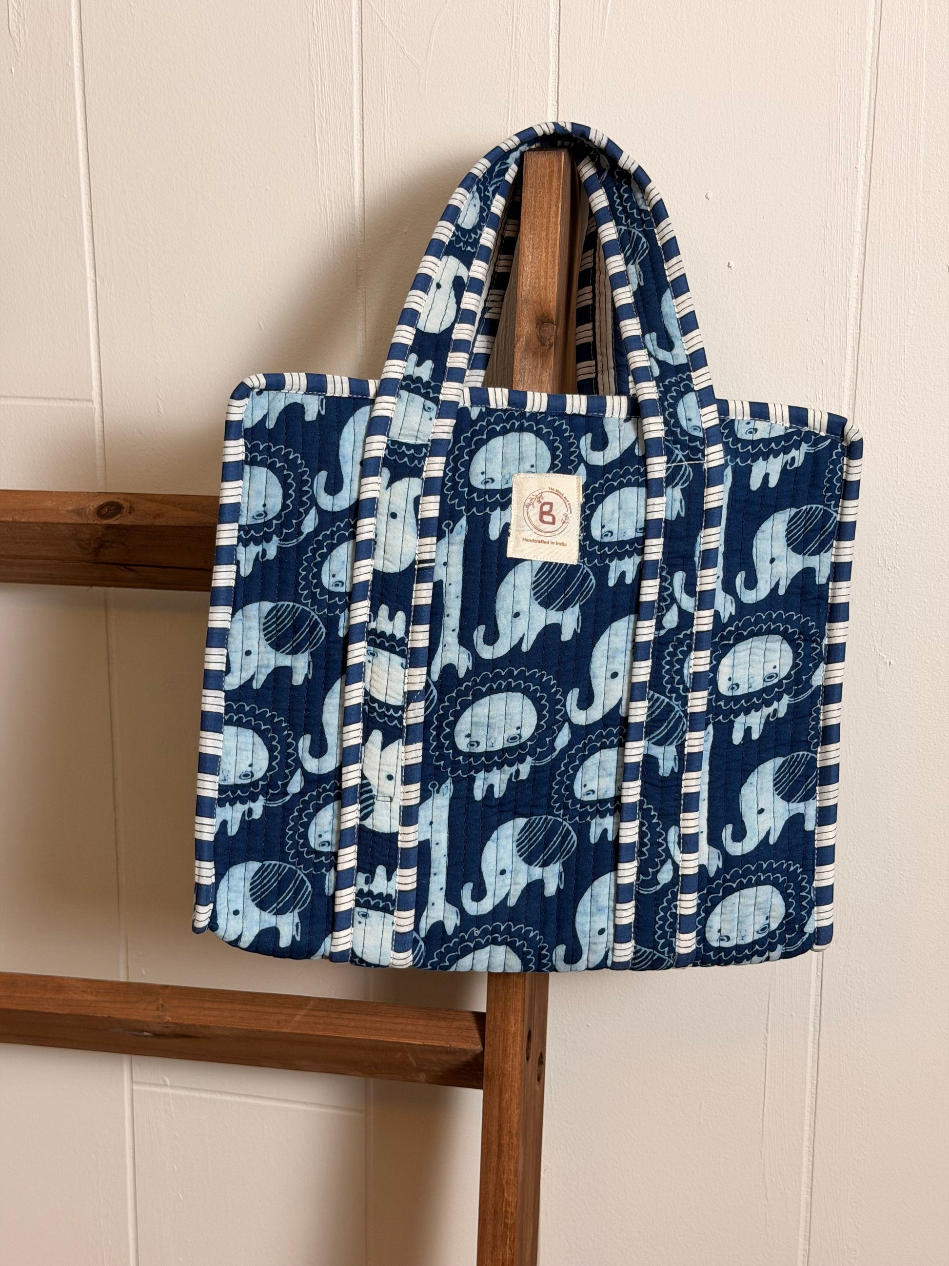 The Block & Bloom navy quilted mini tote featuring a hand block-printed light blue elephant motif and striped trim.