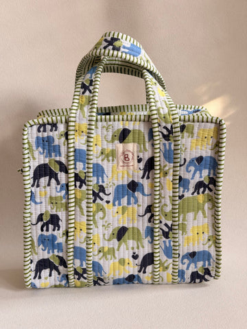 The Block & Bloom quilted mini tote featuring a hand block-printed elephant pattern in blue, yellow, and green.