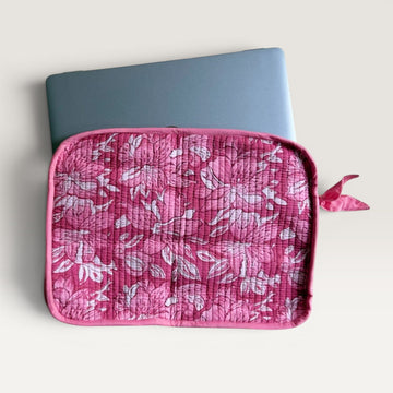 The Block & Bloom quilted laptop sleeve in pink and white floral print with a fabric bow zipper pull.