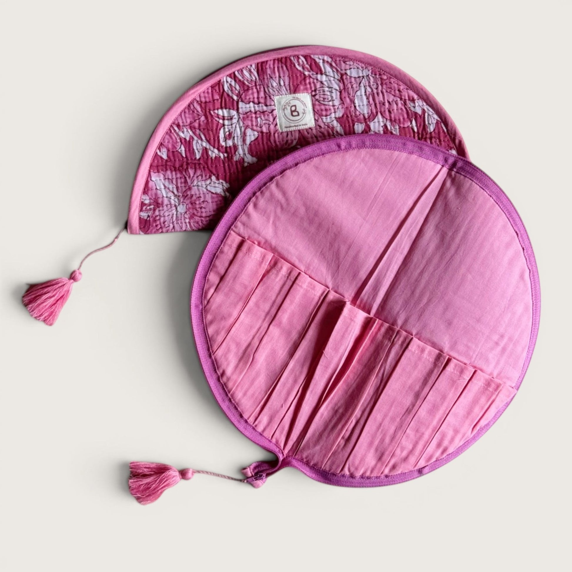 The Block & Bloom quilted makeup brush pouch in pink floral cotton with internal brush slots and tassel zipper pulls.