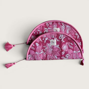 The Block & Bloom quilted makeup brush pouch in pink and white floral cotton with tassel zipper pulls.