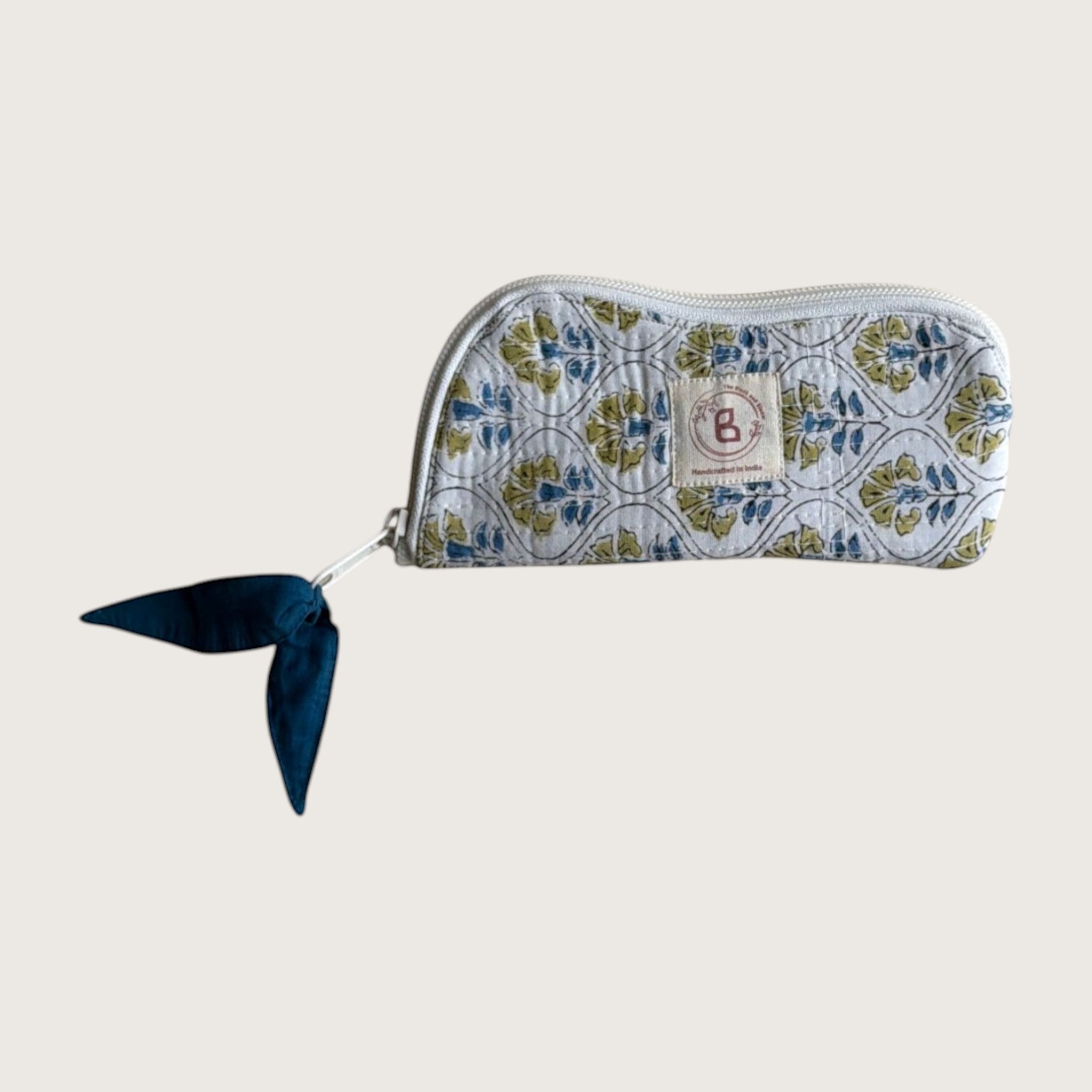 The Block & Bloom quilted cotton sunglasses pouch in white with blue and yellow floral cosmos tile pattern.