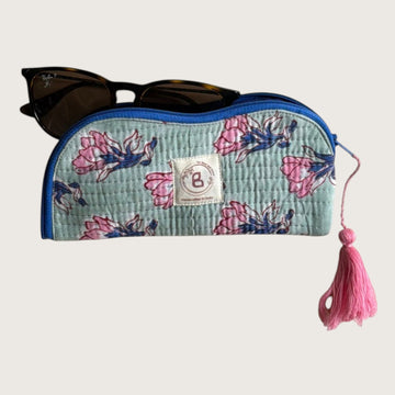 The Block & Bloom quilted cotton sunglasses pouch in sage green with pink floral print and a decorative pink tassel.