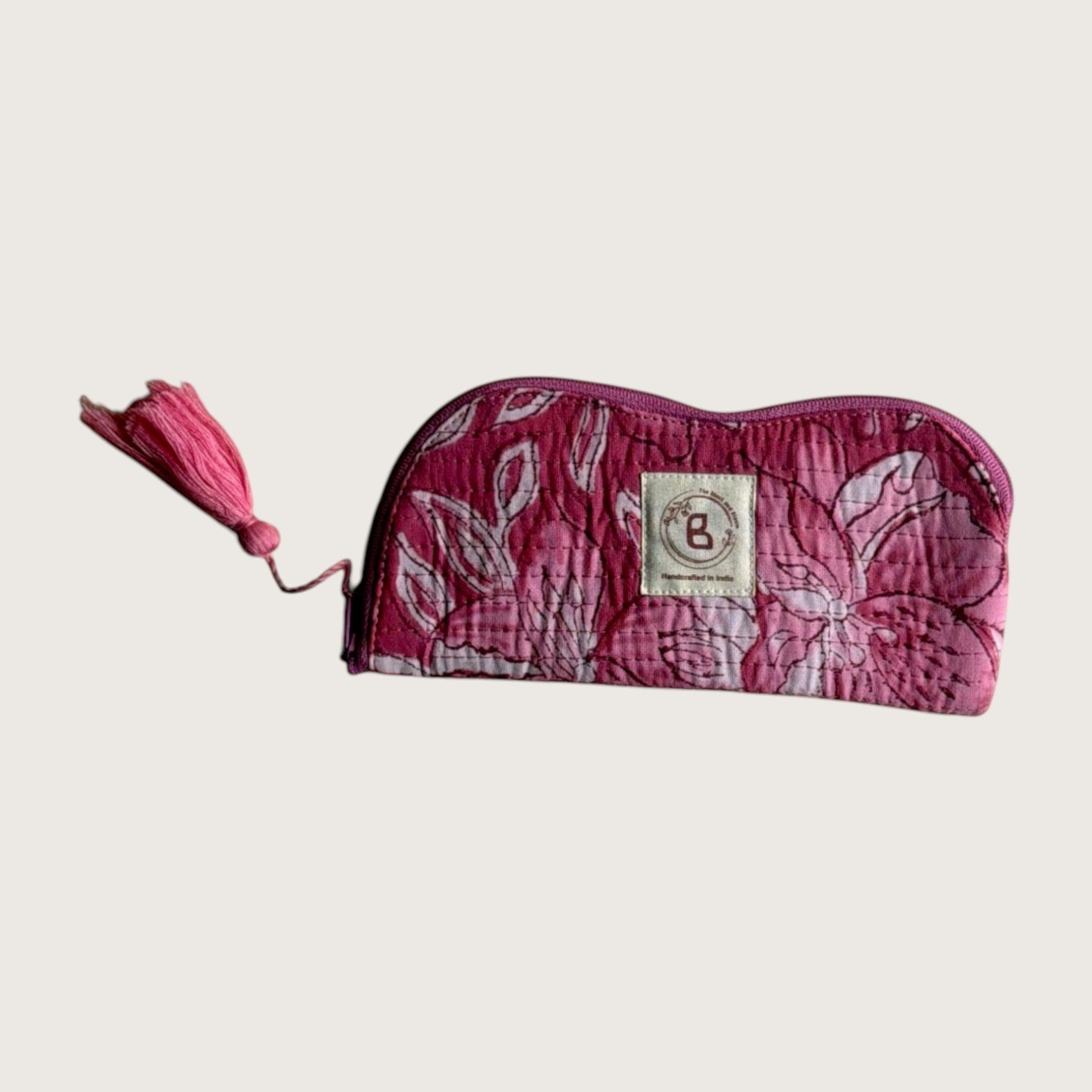 The Block & Bloom quilted sunglasses pouch in pink and white lily floral print with a matching fabric tassel zipper.