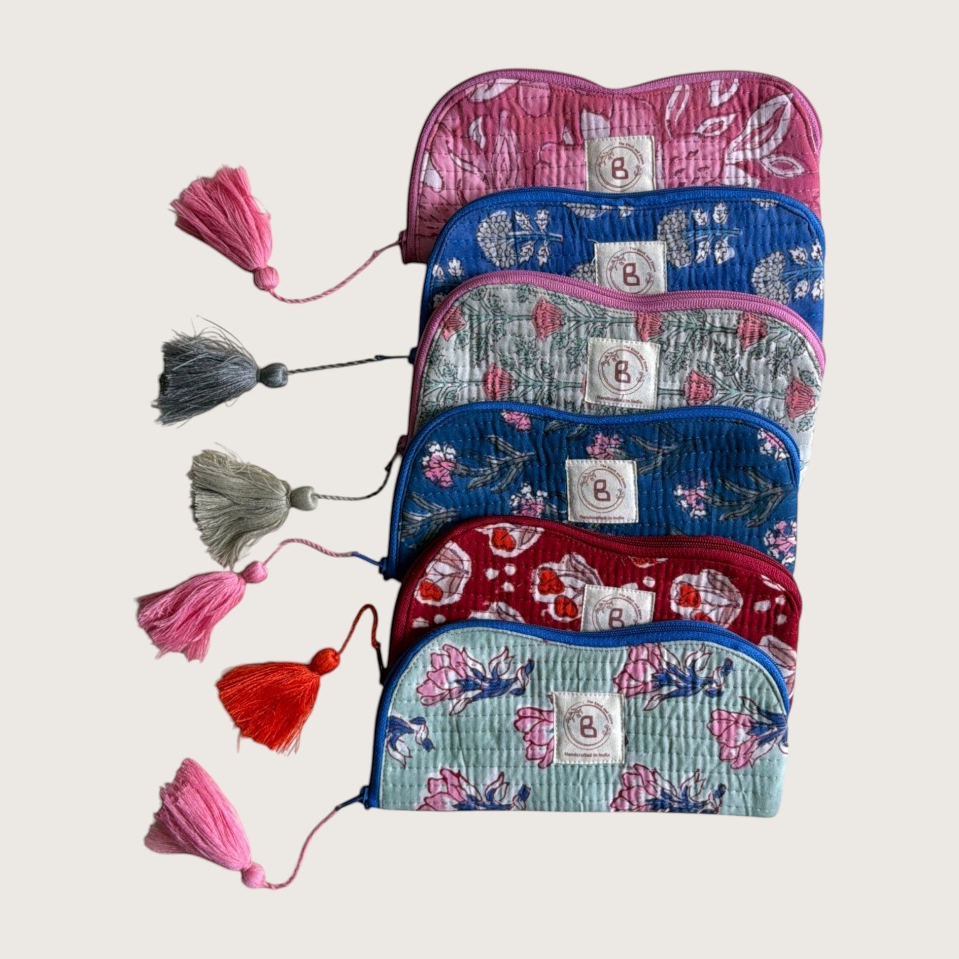 The Block & Bloom quilted cotton sunglasses pouches in various floral patterns with matching decorative tassels.