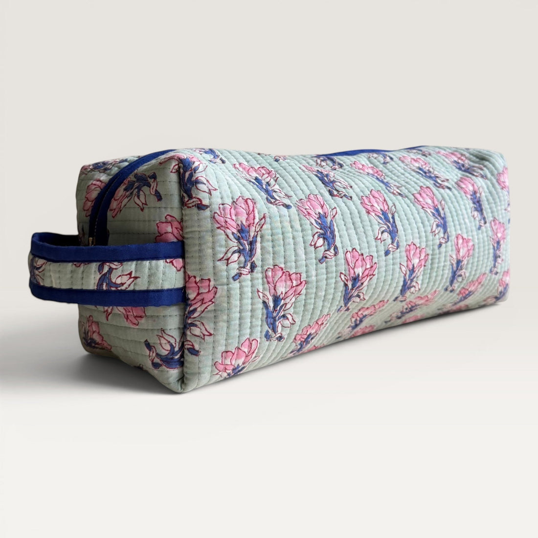 The Block & Bloom quilted sage green hair tool organizer bag with pink saffron flower block print and navy zipper.
