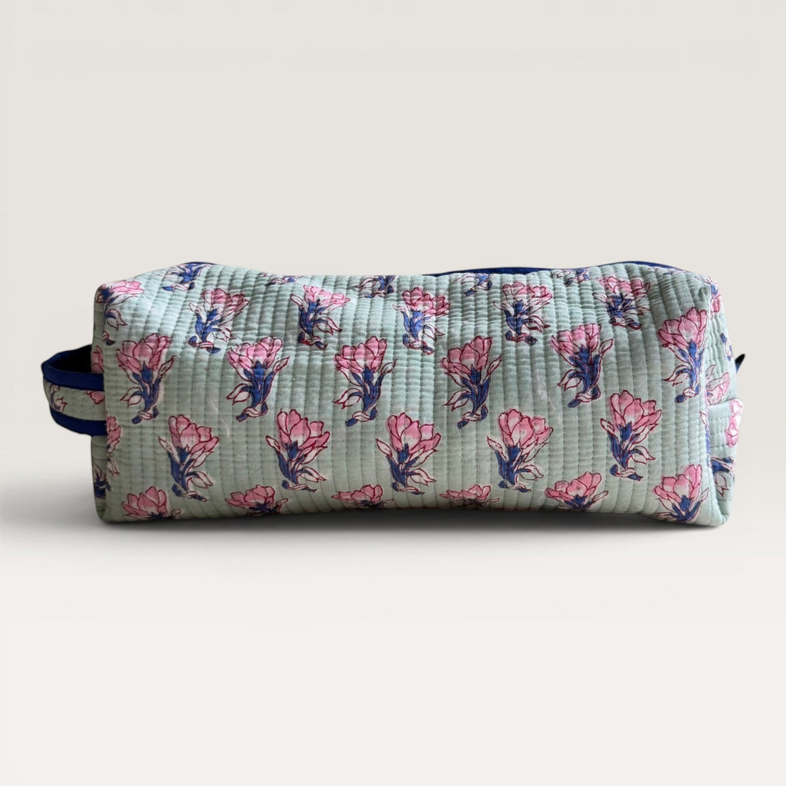 The Block & Bloom quilted sage green hair tool organizer bag with pink saffron flower block print and navy zipper.