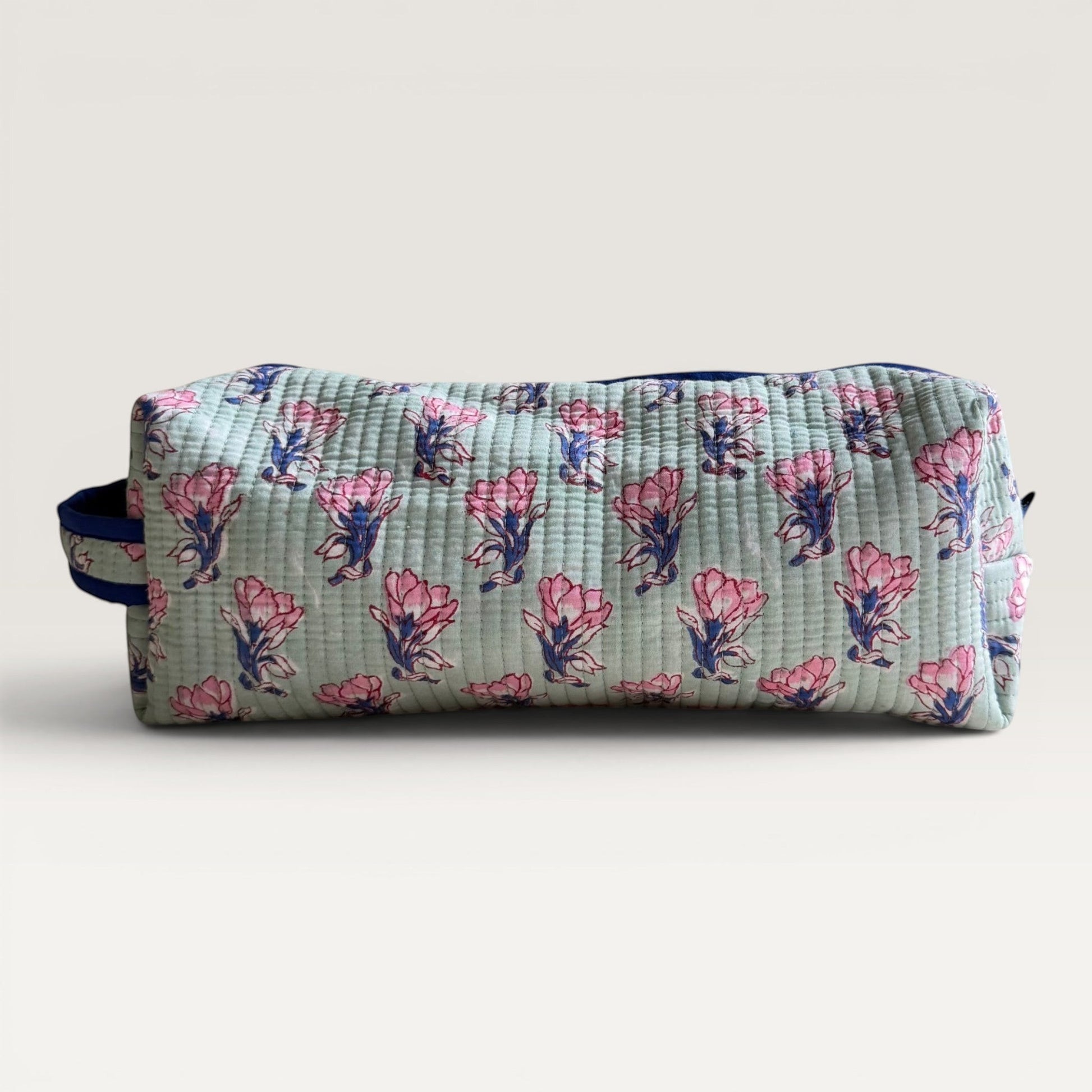 The Block & Bloom quilted sage green hair tool organizer bag with pink saffron flower block print and navy zipper.