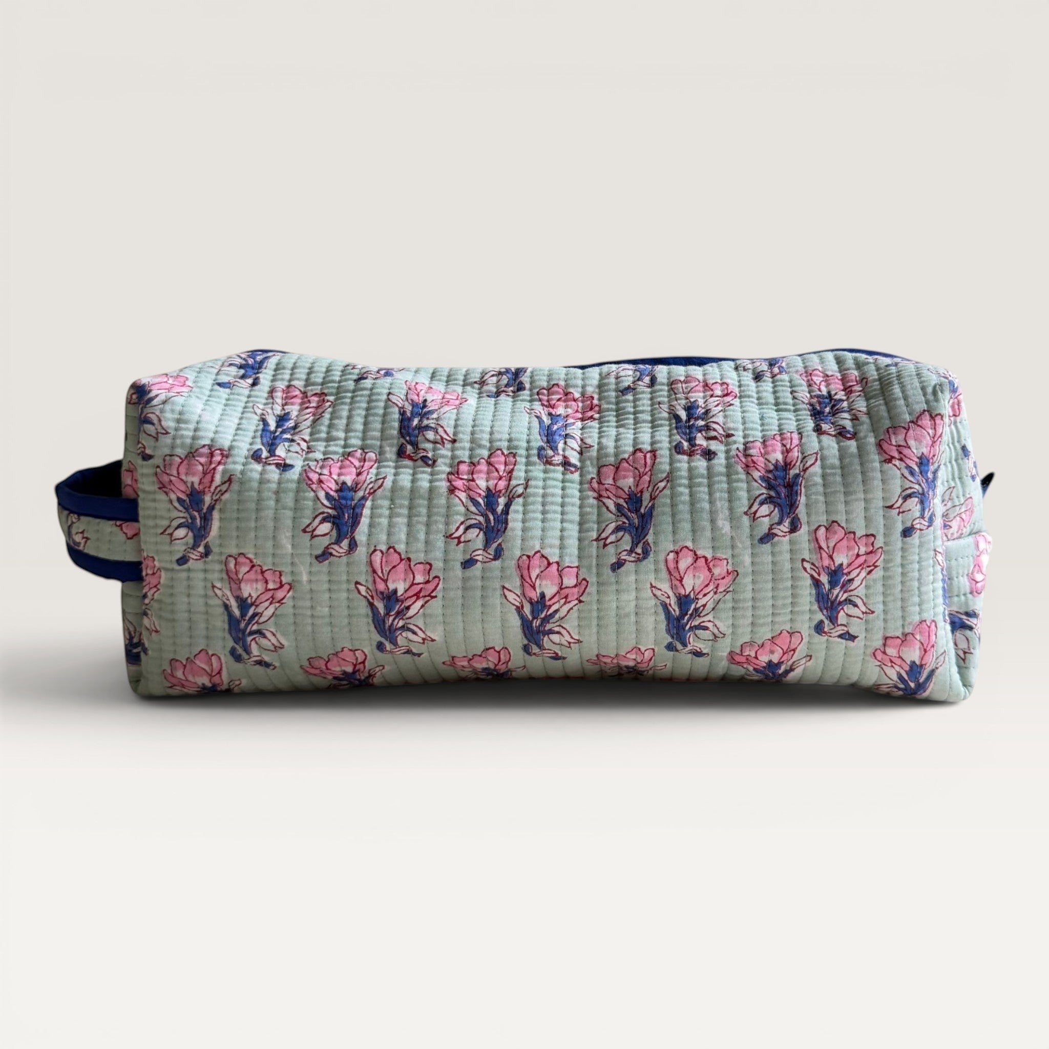 The Block & Bloom quilted sage green hair tool organizer bag with pink saffron flower block print and navy zipper.