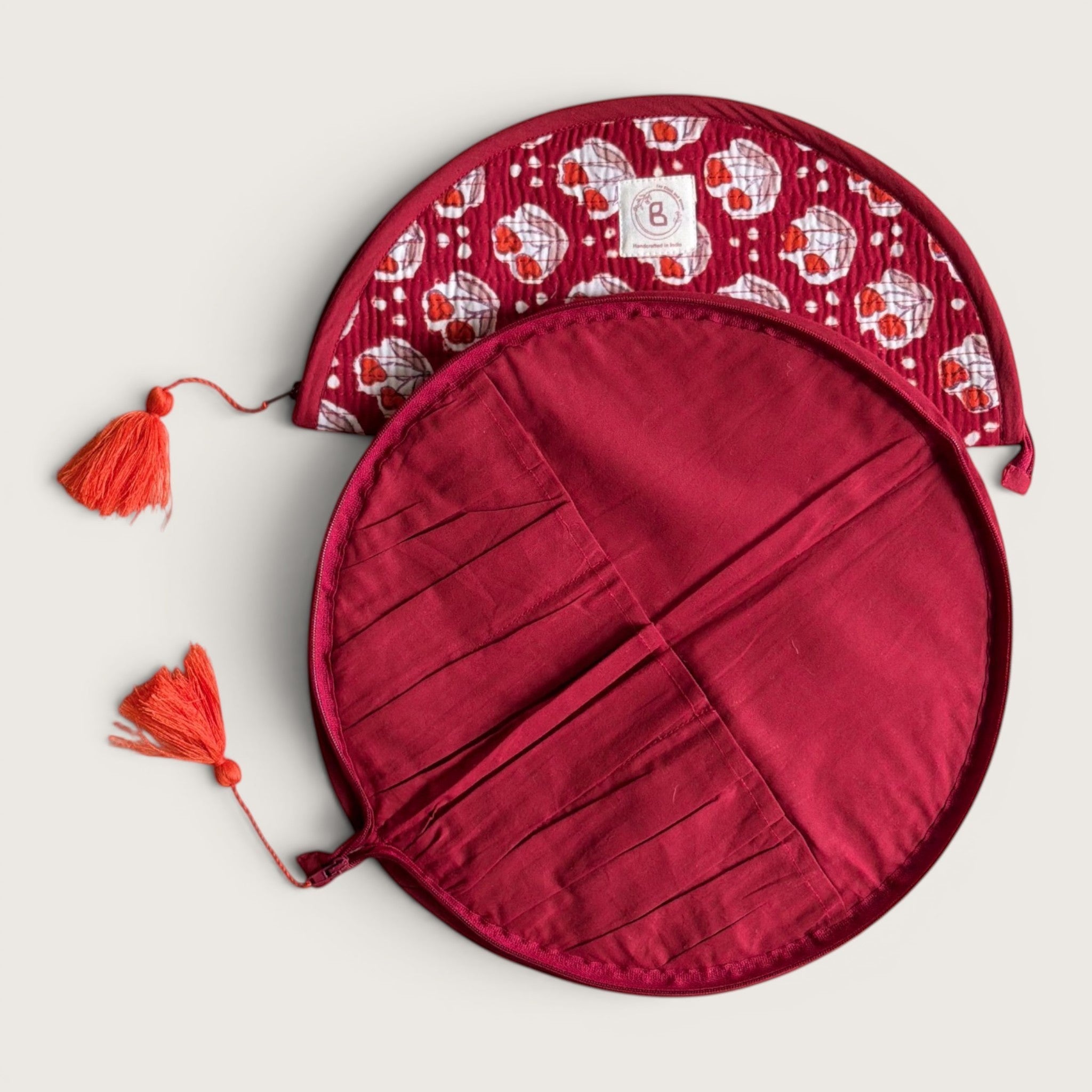 The Block & Bloom quilted makeup brush pouch in burgundy red with red tulip motifs and tassel zipper pulls.