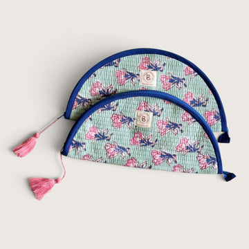 The Block & Bloom quilted makeup brush pouch in sage green with pink saffron flower print and navy blue trim.